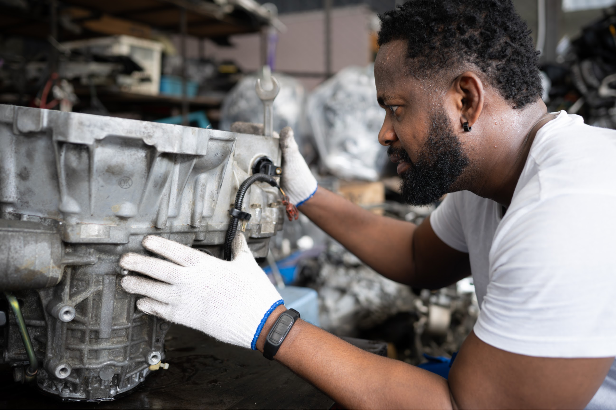 A man is looking at a transmission.