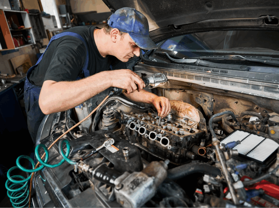 A man looking under the hood of a car