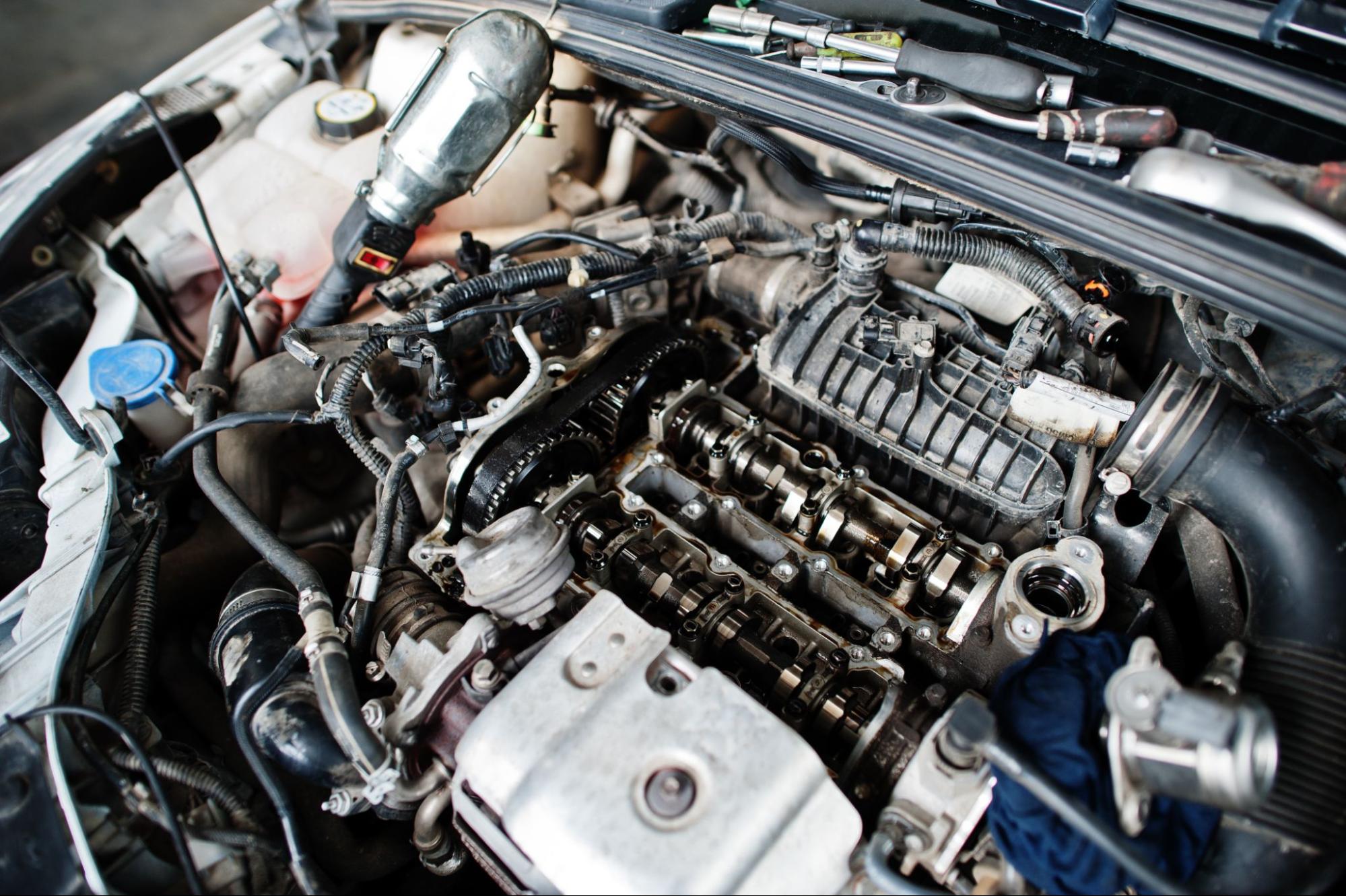 A close-up view of a newly rebuilt engine fully installed in a car, showcasing clean components and precision craftsmanship.